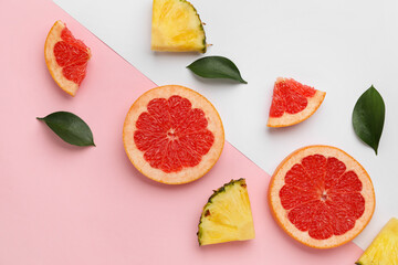 Composition with slices of ripe grapefruit and pineapple on color background
