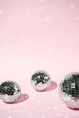 Background of colorful Christmas decor on a pink background. Shiny balls on a pink background.