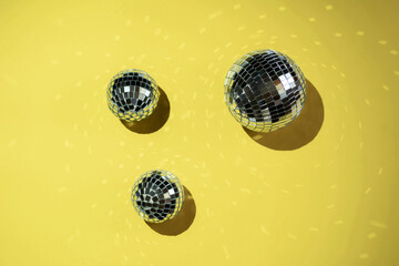 Background of colorful Christmas decor on a yellow background. Shiny balls on a yellow background.