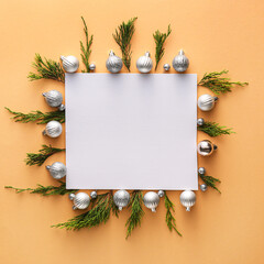 Composition with blank card, Christmas decorations and coniferous branches on color background