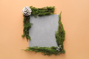 Composition with blank card and coniferous branches on color background
