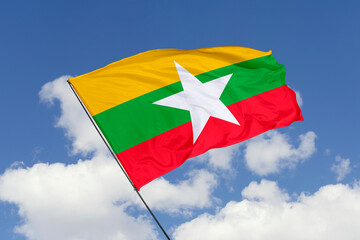 Myanmar flag isolated on the blue sky background. close up waving flag of Myanmar. flag symbols of Myanmar. Concept of Myanmar.