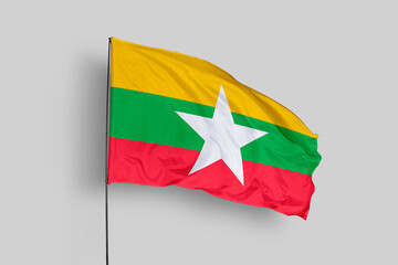 Myanmar flag isolated on the blue sky background. close up waving flag of Myanmar. flag symbols of Myanmar. Concept of Myanmar.