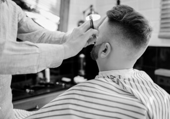 barber works with a straight razor