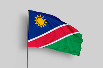Namibia flag isolated on the blue sky background. close up waving flag of Namibia. flag symbols of Namibia. Concept of Namibia.