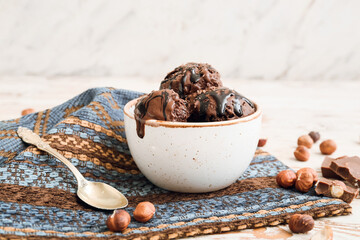 Bowl of tasty chocolate ice cream on table