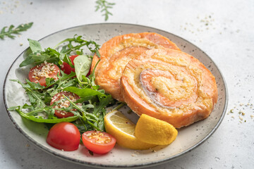 Salmon Pinwheel stuffed with cheese with salad