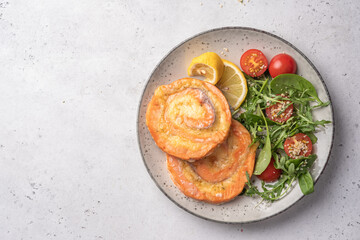 Salmon Pinwheel stuffed with cheese with salad