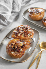 Pear baked with blue cheese, nuts and honey,