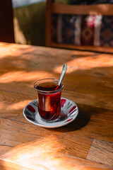 Cup of turkish tea on a wooden table in a cafe