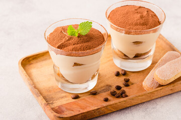 Traditional Italian dessert tiramisu in a glass.