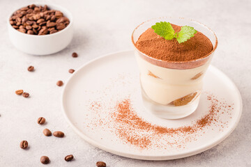 Traditional Italian dessert tiramisu in a glass.