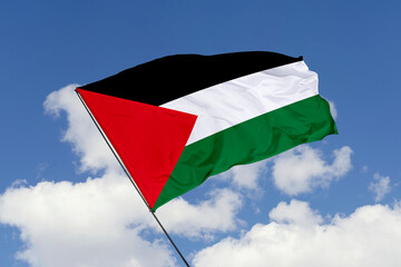 Palestine flag isolated on the blue sky background. close up waving flag of Palestine. flag symbols...