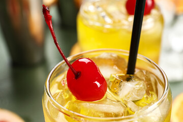 Glass of tasty Tequila Sunrise cocktail on table, closeup