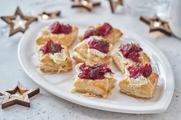 Holiday appetizers with cranberry sauce, brie cheese and thyme