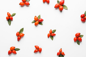Composition with fresh rose hip berries on white background