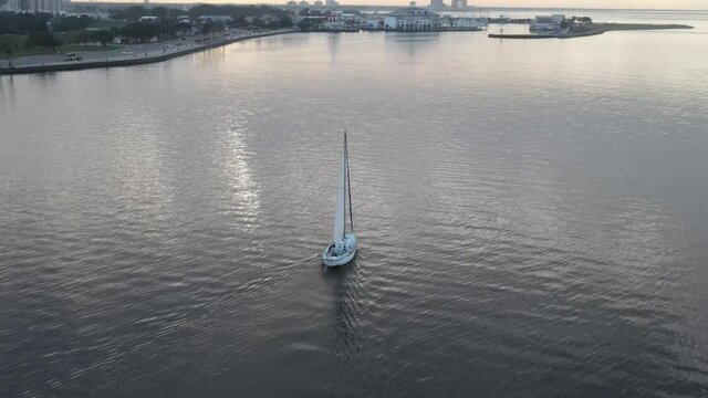 Tranquil Scenery Of Lake With Sailboat Cruising On A Cloudy Day Near New Orleans, Louisiana - aerial drone shot