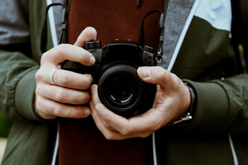 Autumn lifestyle of the photographer. A man with a camera. Hands and a camera.