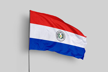 Paraguay flag isolated on the blue sky background. close up waving flag of Paraguay. flag symbols of Paraguay. Concept of Paraguay.