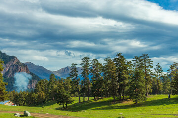 Beautiful mountain landscape, forest and clouds