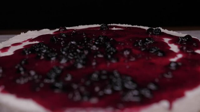pouring raspberry sauce on top of berry pie slow motion 