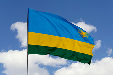Rwanda flag isolated on the blue sky background. close up waving flag of Rwanda. flag symbols of Rwanda. Concept of Rwanda.