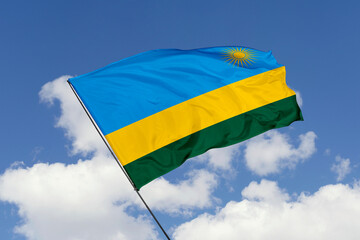 Rwanda flag isolated on the blue sky background. close up waving flag of Rwanda. flag symbols of Rwanda. Concept of Rwanda.