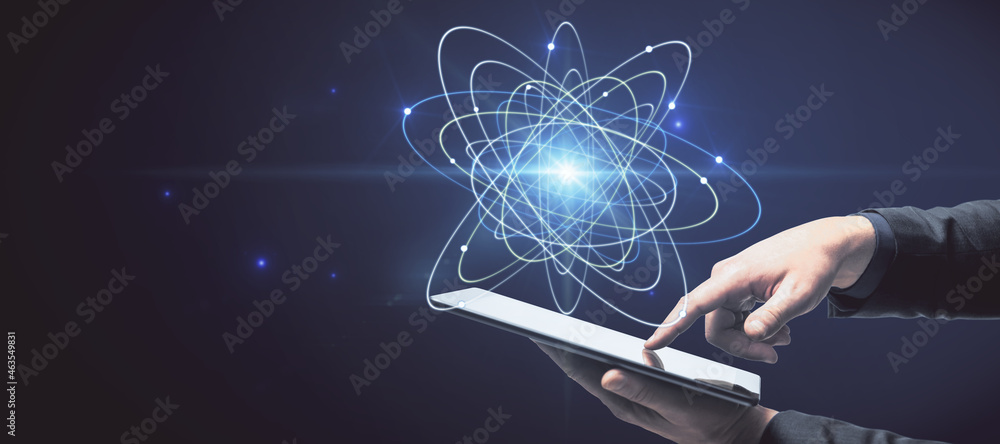Aufkleber close up of businessman hand holding pad with abstract glowing atom hologram on dark background. sci