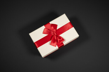 Wrapped vintage gift boxes with red ribbon bow, isolated on black
