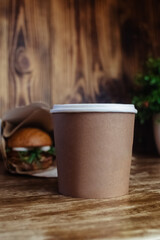 Food delivery. The girl holds paper bags with fast food in her hands. The concept of countering covid 19. Delivery from a restaurant or cafe. Unpacking meal containers