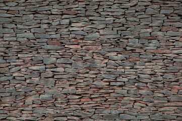stone background. creative gray texture. colored mosaic. wall made of slabs.	