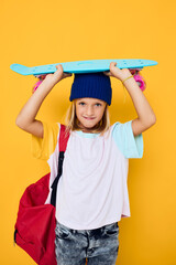 portrait of a girl with a skateboard on his head isolated background