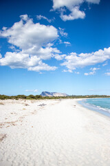 White empty beach landscape. La Cinta, San Teodoro, Sardegna, Italy. Blue sky, clouds