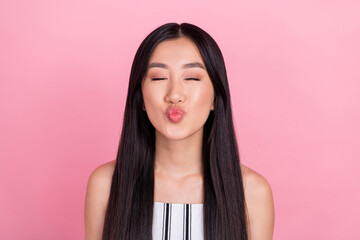 Photo of young flirty brunette lady blow kiss wear white overall isolated on pink color background