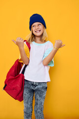 cheerful schoolgirl autumn hats with red backpack education