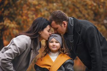 Family mother, father, daughter, beautiful happy together in autumn in nature