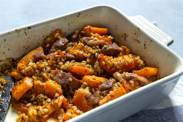 Healthy food. Pumpkin barley meat bake in oven on table.