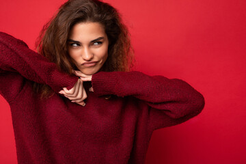 Photo of young funny self-confident beautiful brunette curly woman with sincere emotions wearing...