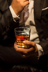 Closeup businessmen holding a glass of whiskey