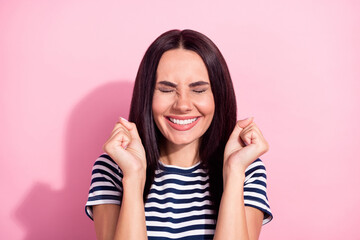 Fototapeta premium Photo ot positive happy cheerful young woman raise fists smile sale excited isolared on pastel pink color background