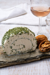 Cheese collection, fresh white soft goat French cheese roll with aromatic herbs and chives