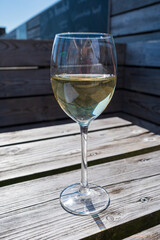 Glasses of white wine served on outdoor terrase, summer vacation