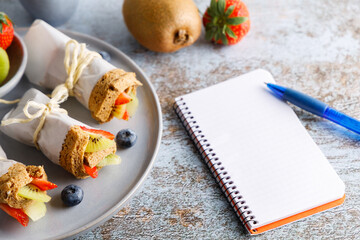 Healthy breakfast fruit rolled in a slice of bread. Homemade healthy vegetarian breakfast fruit rolled in a slice of wholegrain bread. Top view.