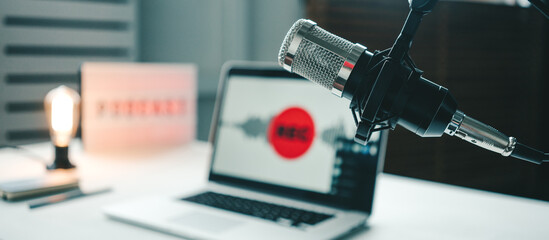 Local podcast studio interior. Microphone, laptop and cozy streaming workplace