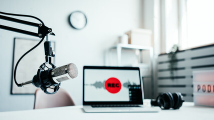 Podcast studio interior. Microphone, laptop and cozy broadcasting workplace