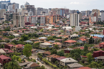 Naklejka premium ariel panoramic view of old city in forest and skyscrapers from the mountains