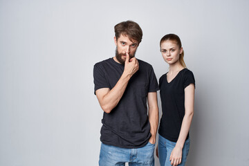 fashionable man and woman socializing together posing fashion light background