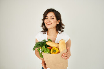 an item in a white t-shirt a bag with groceries vegetables shopping in a supermarket