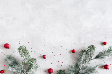 Christmas composition. Fir tree branches, red decorations on gray background. Christmas, winter, new year concept. Flat lay, top view, copy space - 463562875