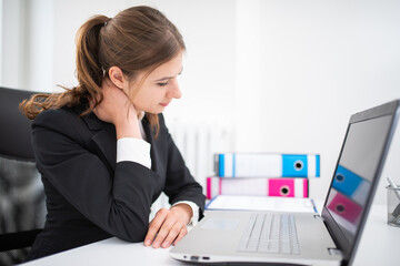 Business woman with neck pain in office